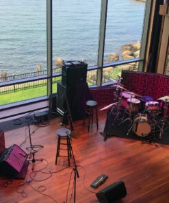 Impression Pro Series Bass Traps standing behind drumset and amplifier with view of water