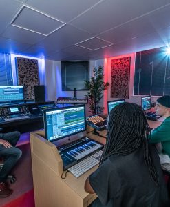 School of Electronic Music in Manchester, UK with Students in Midi Studio with Alpha Pro Series Acoustic Panels on walls in 2D(a) Gray Elm veneer with black fabric