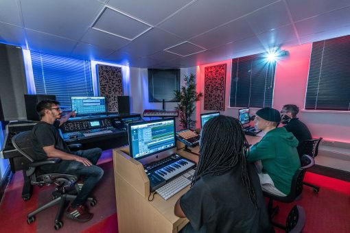 School of Electronic Music in Manchester, UK with Students in Midi Studio with Alpha Pro Series Acoustic Panels on walls in 2D(a) Gray Elm veneer with black fabric