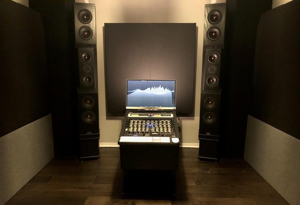 Mastering studio with GIK Acoustics Soffit Bass Traps, 244 Bass Traps in standard black fabric behind speakers.